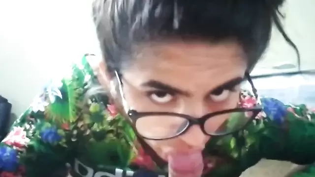 A dressed-up Argentinean woman giving a blowjob
